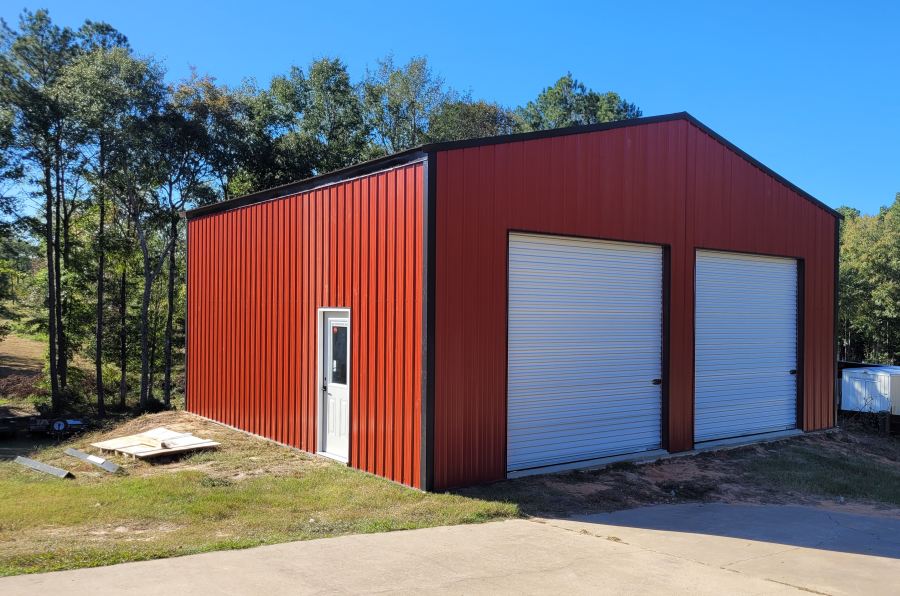 Red Metal Building with walk-in door, two bays, with dark trim - built by J&A Construction - Metal Buildings and more - Jason Carpenter West Monroe, Louisiana Call 228-627-2564 for more info