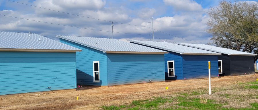 Blue colors chosen by owner and buildings constructed by J&A Construction picture from the back showing metal roofing under construction - Call 228-627-2564 for more info